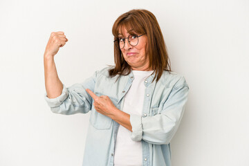 Middle age caucasian woman isolated on white background showing strength gesture with arms, symbol of feminine power