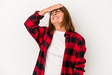 Middle age caucasian woman isolated on white background laughs joyfully keeping hands on head. Happiness concept.