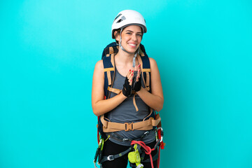 Young Italian rock-climber woman isolated on blue background applauding after presentation in a conference