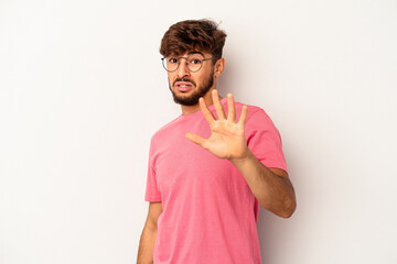 Young mixed race man isolated on grey background being shocked due to an imminent danger