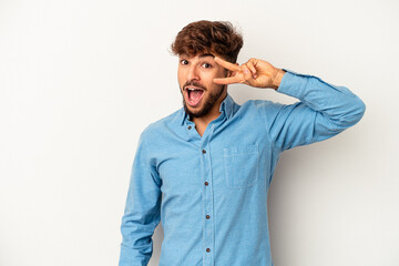 Young mixed race man isolated on grey background dancing and having fun.