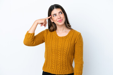 Young Italian woman isolated on white background making the gesture of madness putting finger on...