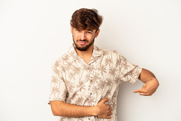 Young mixed race man isolated on grey background having a liver pain, stomach ache.