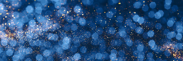 Blue and golden sparkling glitter bokeh background, christmas texture. Holiday lights. Abstract...