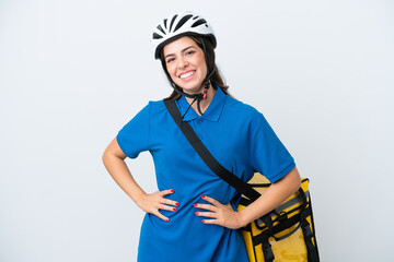 Young delivery woman with thermal backpack isolated on white background posing with arms at hip and smiling