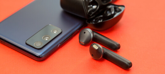 Audio headphones without wires included with a new smartphone on offer