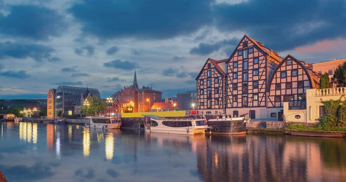 Bydgoszcz, Poland. Old half-timbered buildings on embankment of Brda (static image with animated sky and water)
