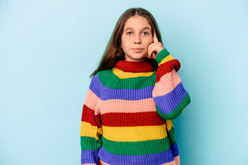 Little caucasian girl isolated on blue background pointing temple with finger, thinking, focused on a task.