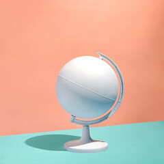 Blank white globe on a pedestal over a bicolor background