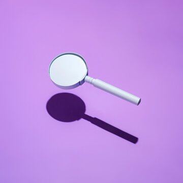 Floating Magnifying Glass With Drop Shadow On Purple