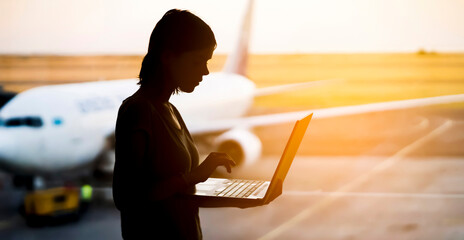 Woman with a laptop in the airport.