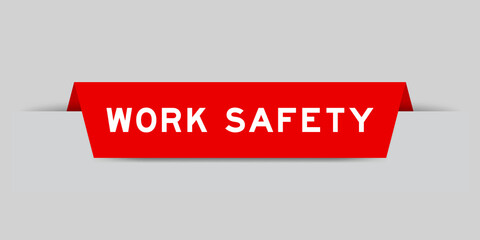 Red color inserted label with word work safety on gray background