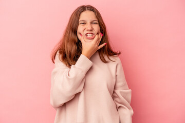 Little caucasian girl isolated on pink background having a strong teeth pain, molar ache.