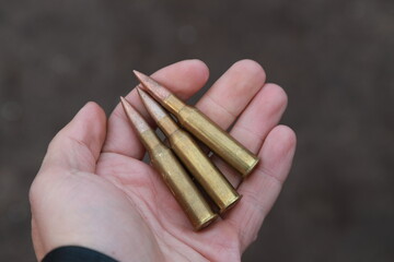 Vintage rifle cartridges in hand