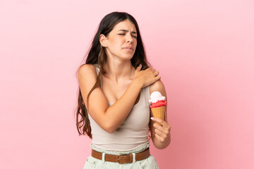 Young caucasian woman with a cornet ice cream isolated on pink background suffering from pain in...
