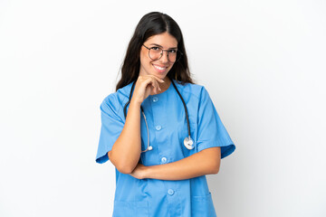 Young surgeon doctor caucasian woman isolated on white background with glasses and smiling