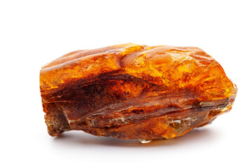 Natural amber. A piece of yellow opaque natural amber on white background.