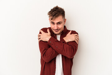 Young caucasian man isolated on white background hugs, smiling carefree and happy.