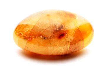 Natural amber. A piece of yellow opaque natural amber on white background.