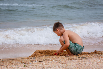 young boy playing in the sand