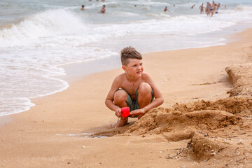 young boy playing in the sand