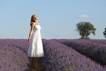 Full body of woman breathing in lavender field