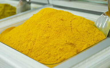 spices by weight are poured into a container: curry