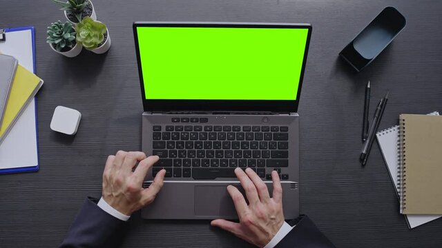 Businessman checking email and replying to letters online on laptop in office