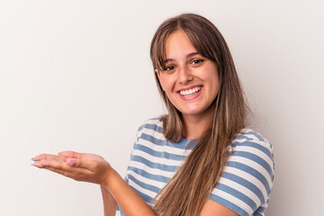 Young caucasian woman isolated on white background holding a copy space on a palm.