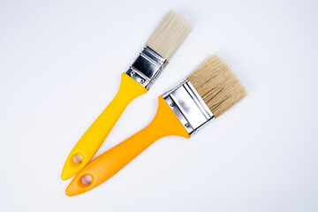 Two clean brushes on a white background. Construction. Tools for building houses and apartments