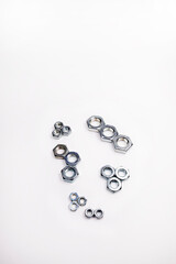 Many different screws on a white background. Equipment repair and construction