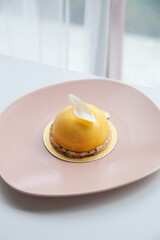 Mango and passion fruit mousse decorated with white chocolate