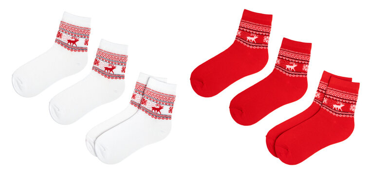 Pair of red and white woman's Nordic style socks with Norwegian knitted rose pattern (Selburose) isolated on a white background