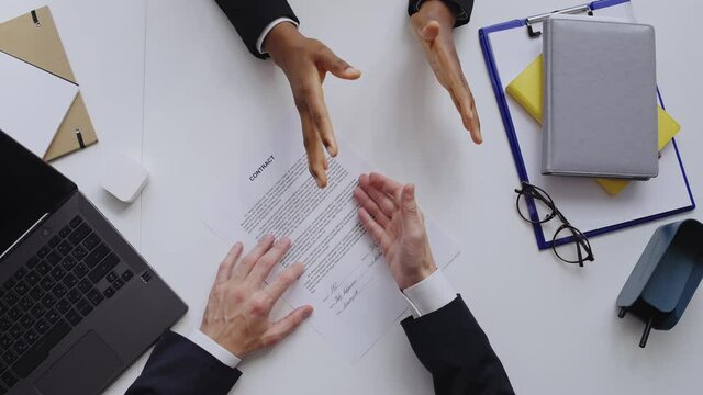 Partners arguing about contract terms, man tearing it apart. Lorem ipsum text