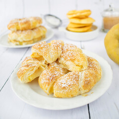 Apple rings in puff pastry, with cinnamon and powdered sugar.