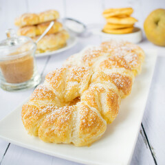 Apple rings in puff pastry, with cinnamon and powdered sugar.