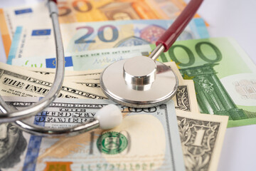 Stethoscope on US dollar and Euro banknotes, Finance, Account, Statistics, Analytic research data and Business company  medical health meeting concept