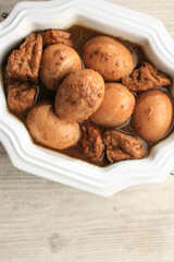 Semur Telor is Boiled Eggs Cook with Soy Sauce for Family Menu on White Table