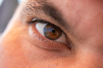 the man's brown eye is close up