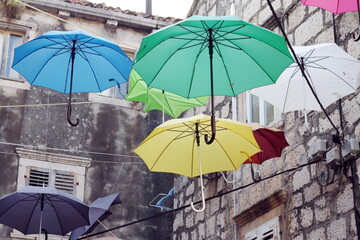 Umbrellas with stone houses background