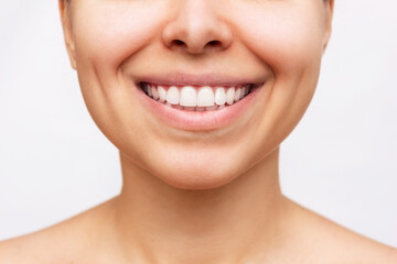 Cropped shot of a young caucasian woman with perfect white even teeth isolated on a white...