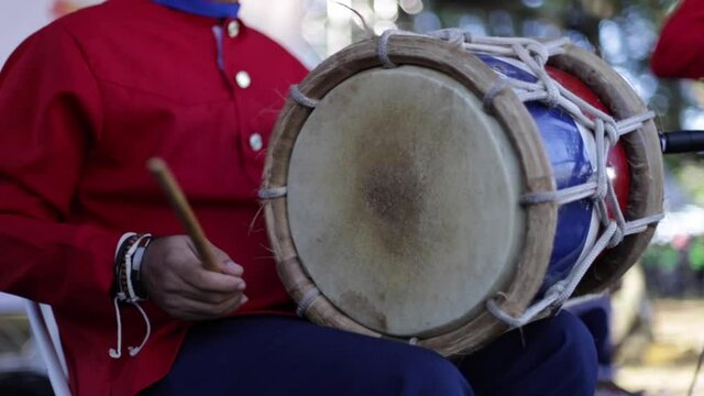man playing instrument tambora merengue in dominican republic
