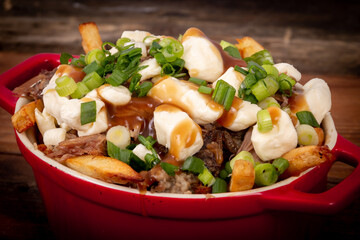 duck confit poutine dish on wood table