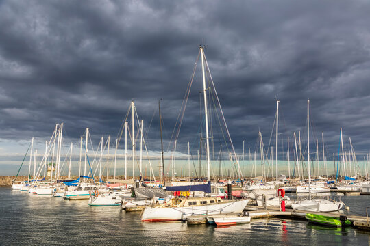 Australia, Victoria, Melbourne, Storm clouds over boats moored inRoyal Melbourne Yacht Squadron marina