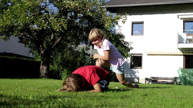 Two kids are playing in the garden