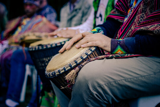 Sao Paulo, SP, Brazil - November 11 2021: Caucasian people, with arms and hands with colored rings and bracelets, playing African drum details