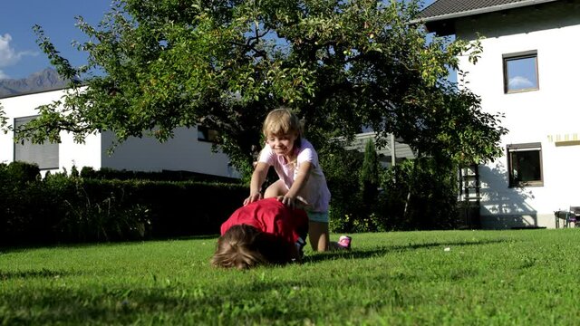 Two kids are playing in the garden