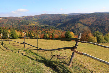 wooden fence in autumn mountains