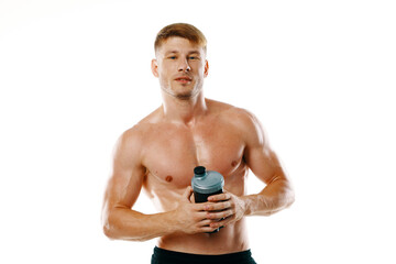 Fototapeta premium a man an athlete with a pumped-up body drinks from a bottle
