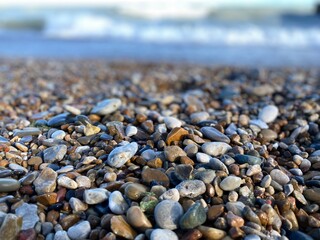 Small, wet stones along the shore of a Lake Michigan beach